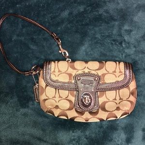 Coach brown signature wristlet with a buckle